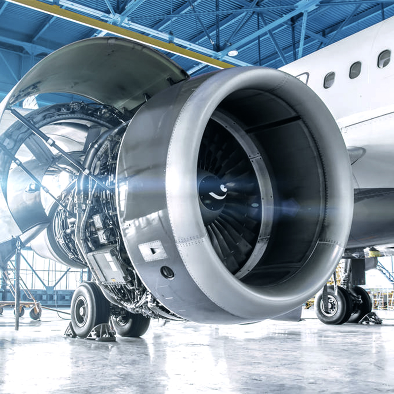 Close-up of a jet engine turbine, representing high-precision aerospace manufacturing technology.